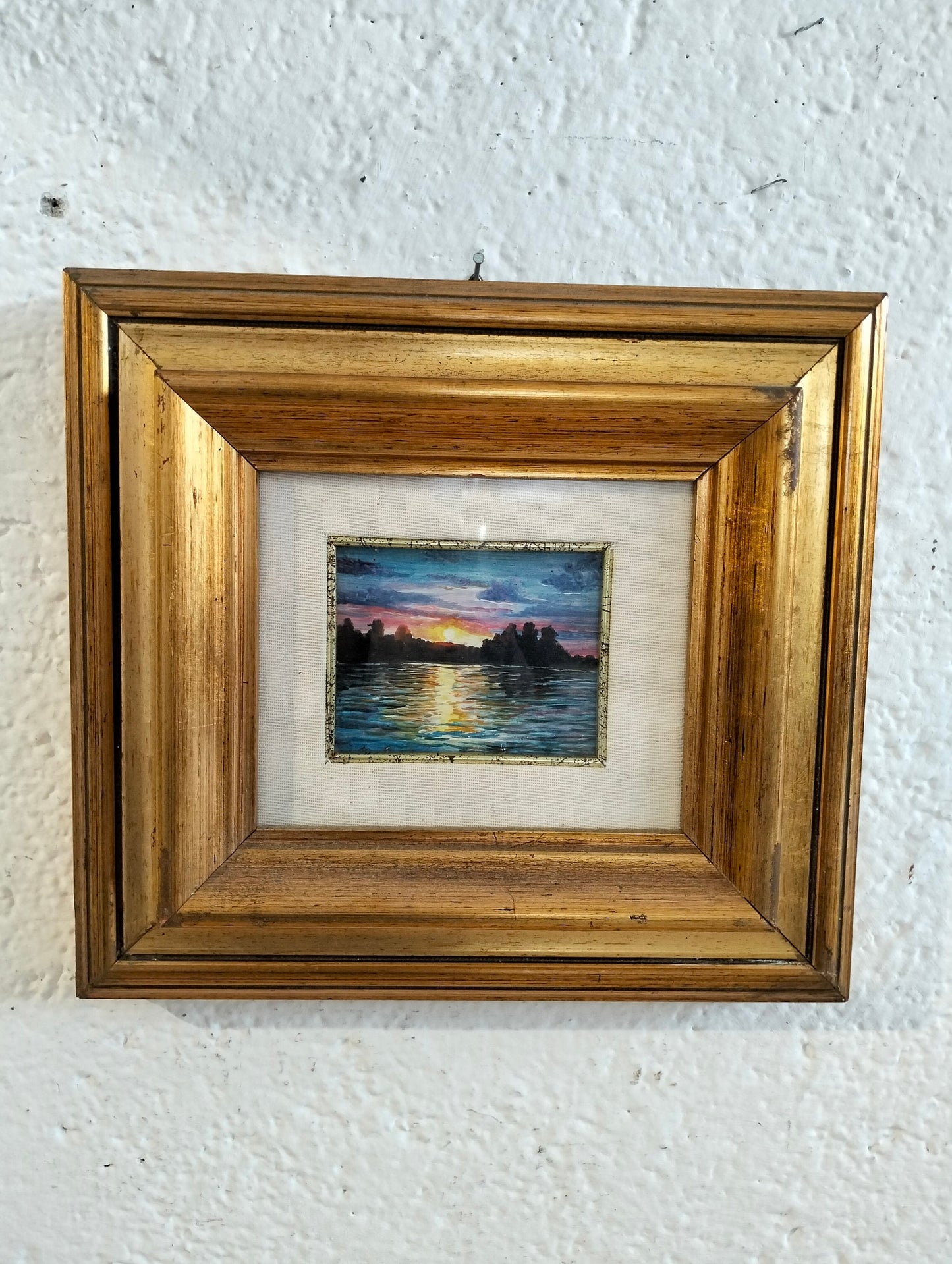Hand painted picture of a sunset with a golden frame