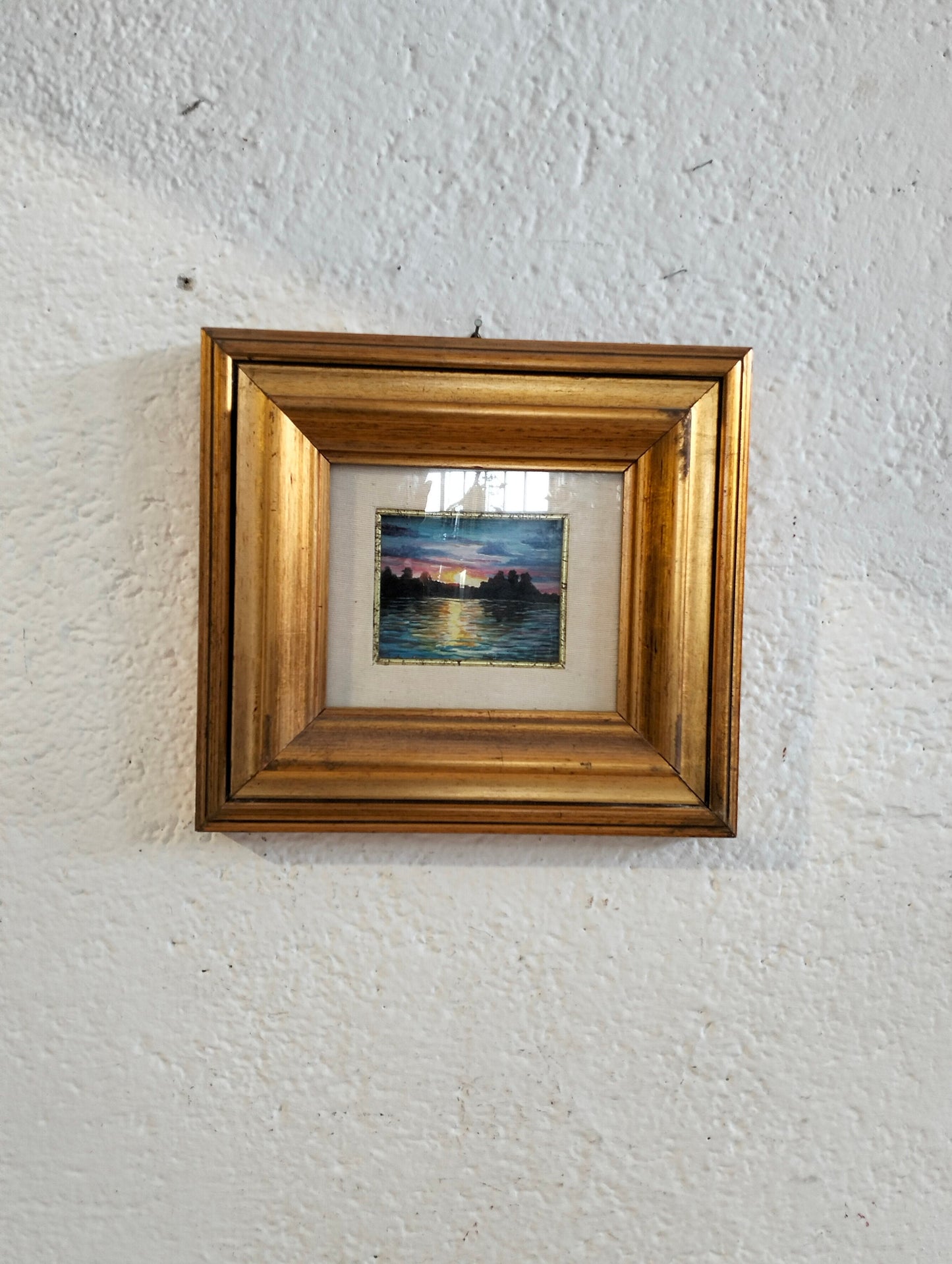 Hand painted picture of a sunset with a golden frame