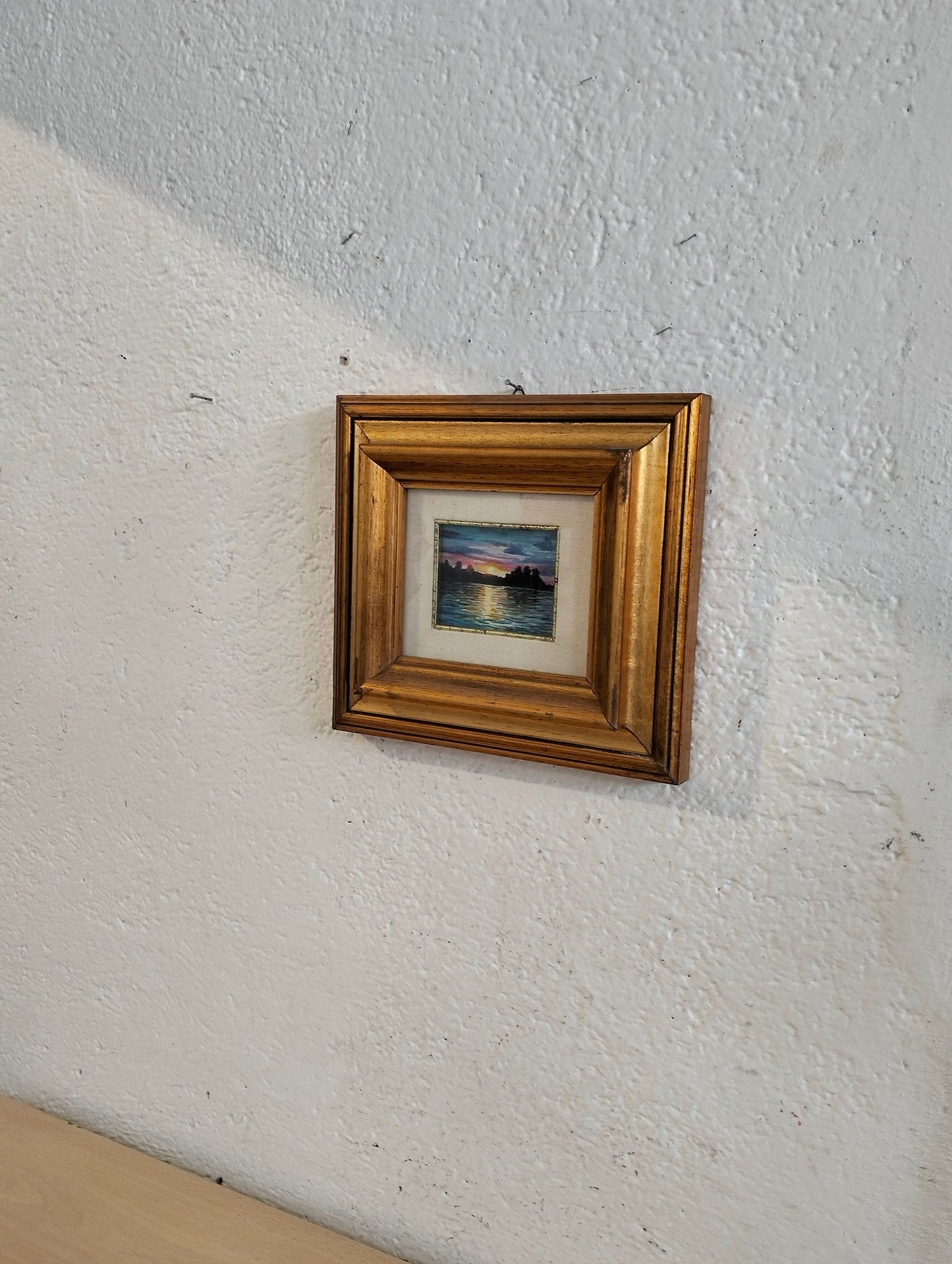 Hand painted picture of a sunset with a golden frame