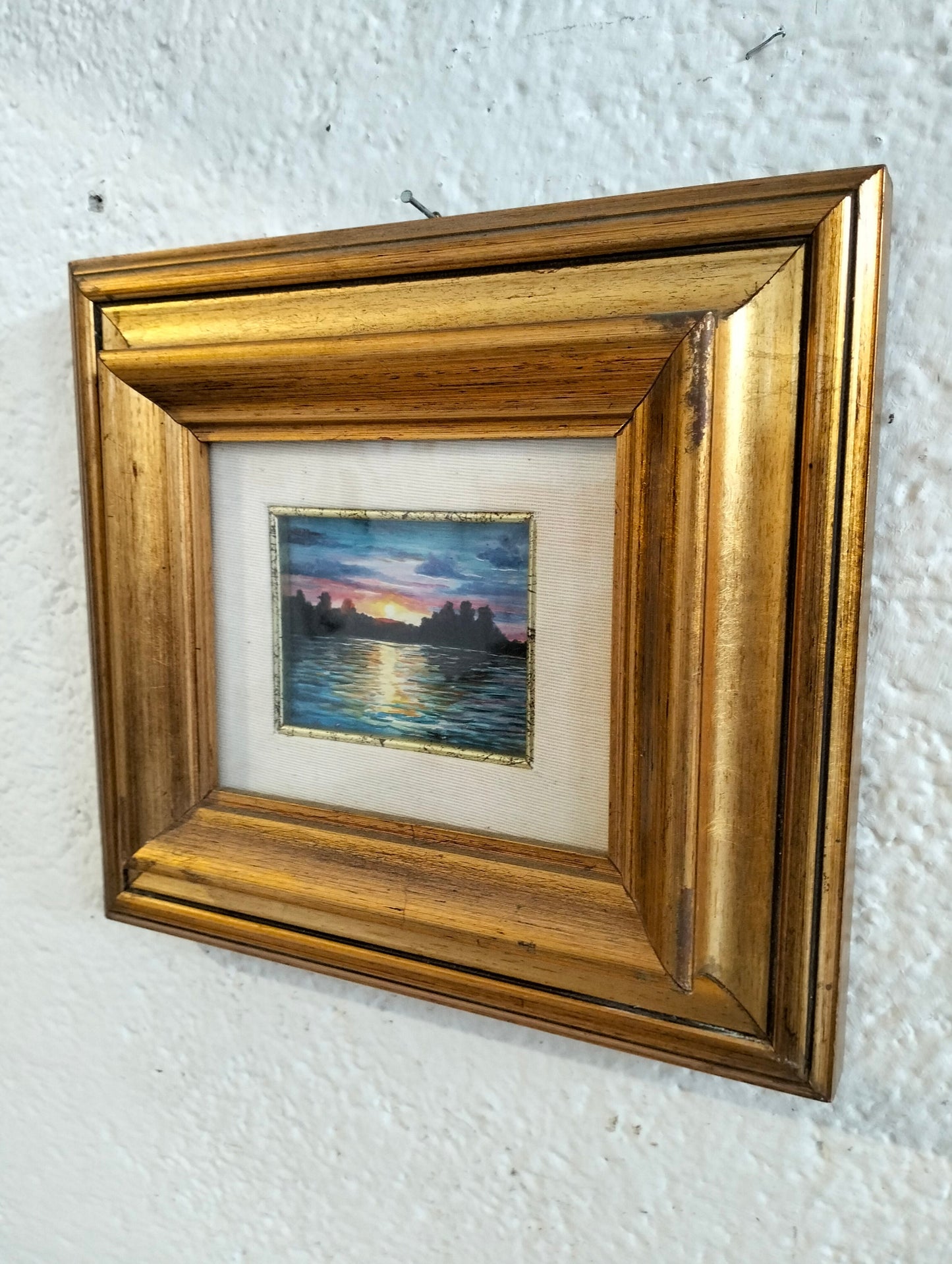 Hand painted picture of a sunset with a golden frame