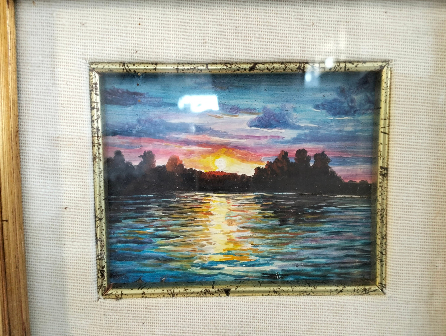 Hand painted picture of a sunset with a golden frame