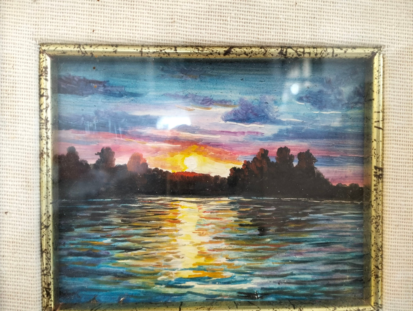 Hand painted picture of a sunset with a golden frame