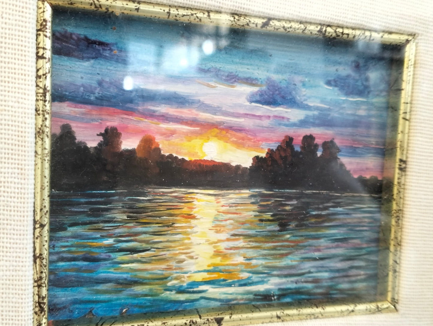 Hand painted picture of a sunset with a golden frame