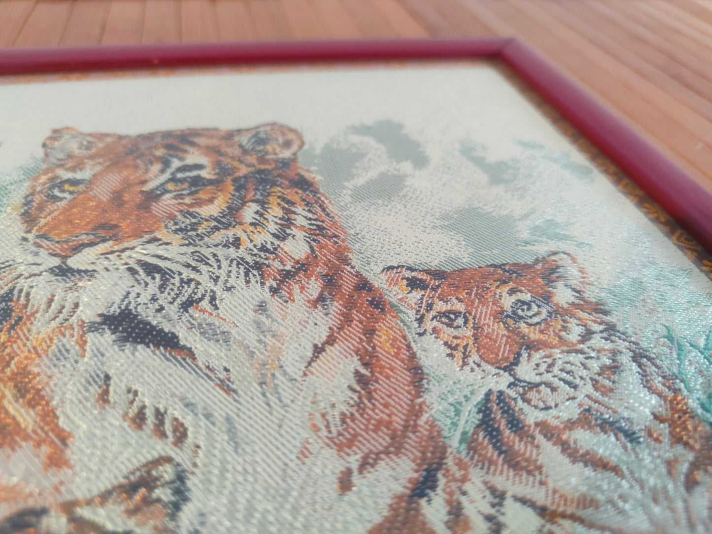 Chinese crochet painting depicting two tigers in a red frame