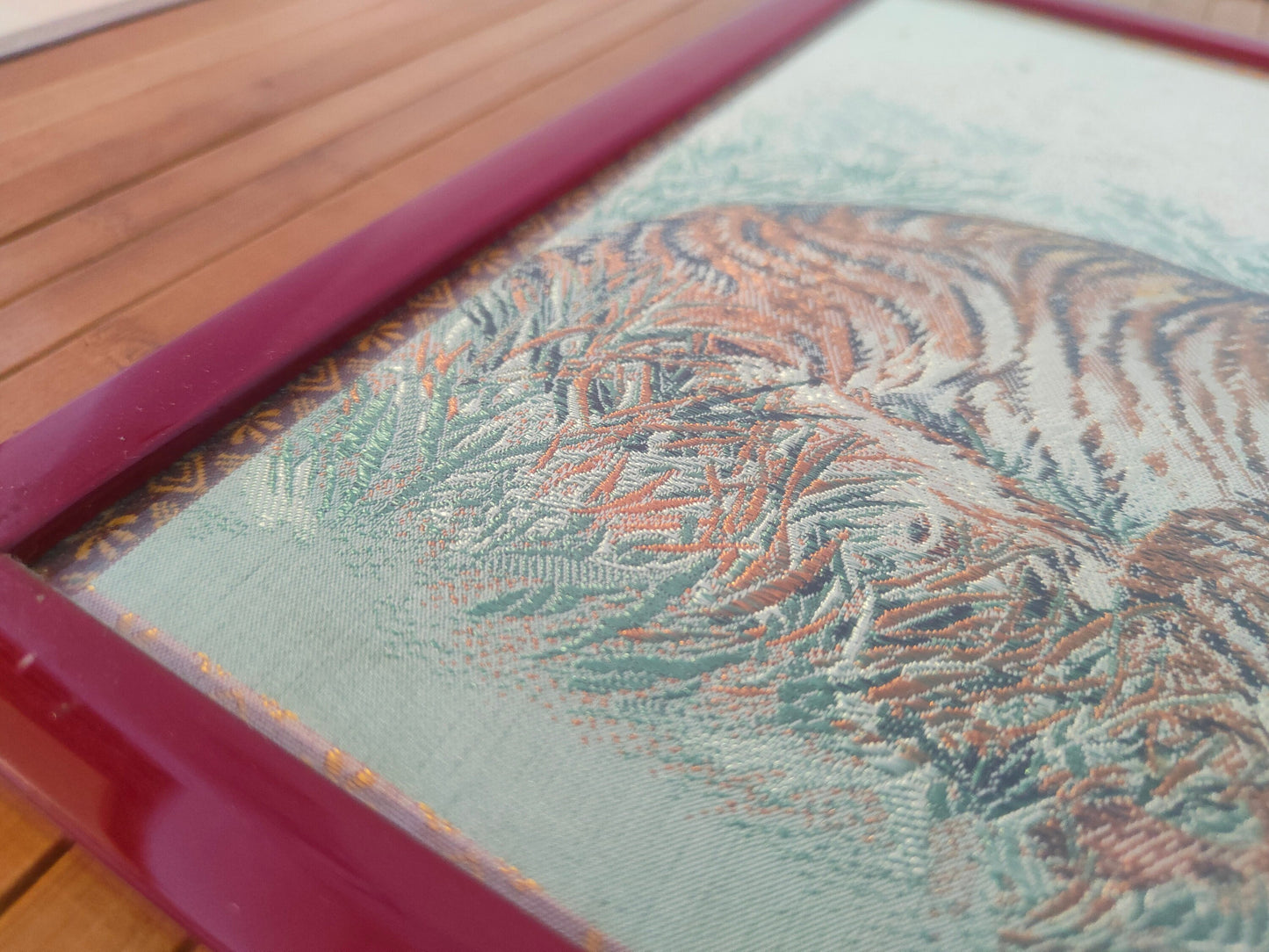 Chinese crochet painting depicting two tigers in a red frame