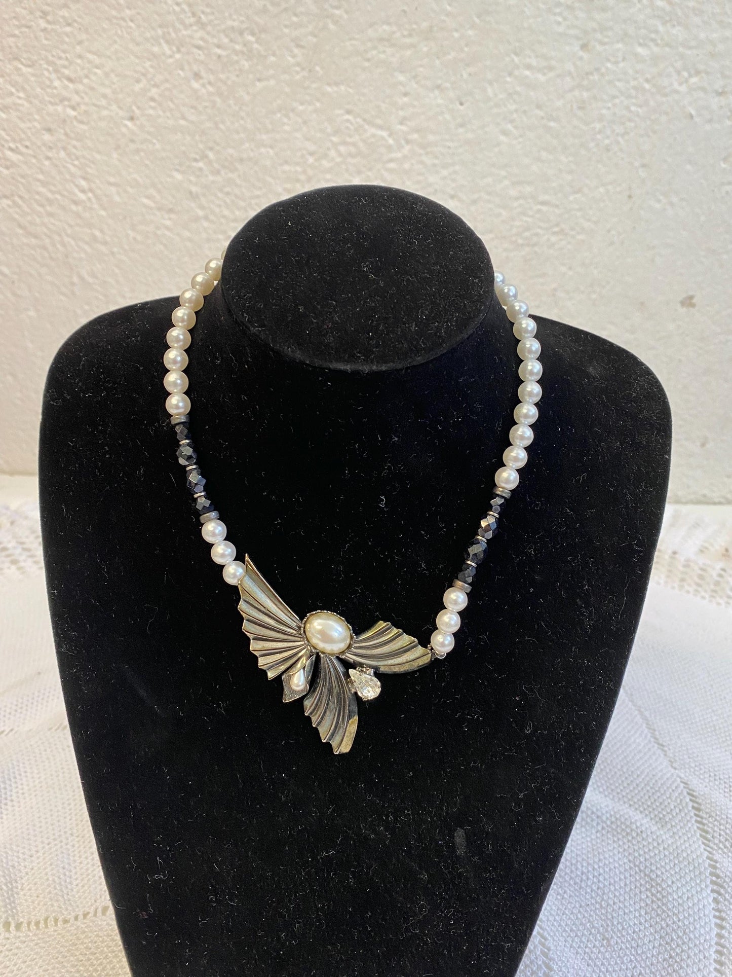 Collana sintetica perline bianche nere con ciondolo ali dorate e perla centrale, diametro 13 cm, gioiello fatto a mano elegante