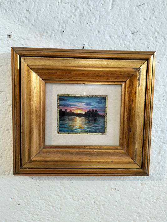 Hand painted picture of a sunset with a golden frame